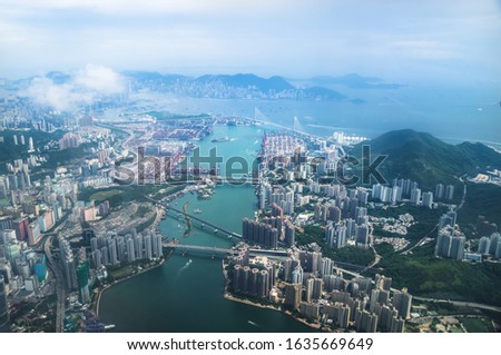 Aerial view of Hong Kong islands with skyscrapers and industry from a flying airplane, China