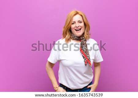 middle age woman with a big, friendly, carefree smile, looking positive, relaxed and happy, chilling