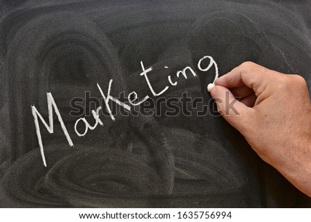 
The word marketing written with a chalk on the blackboard