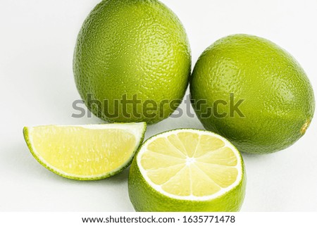 Ripe, fresh lime. Slices, quarter, whole fruits. Unfolded white isolated background. Green citrus photo. Fresh composition.