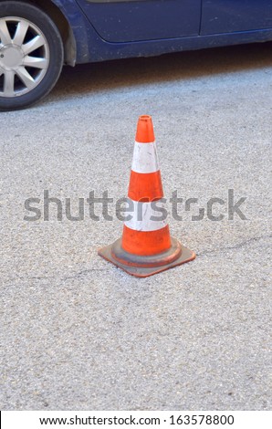 Traffic cone on the asphalt, security symbol and obstacle