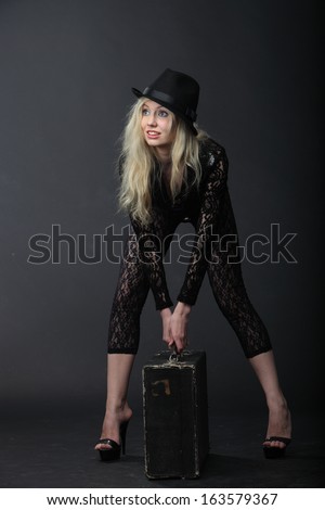 Girl in a hat with suitecase