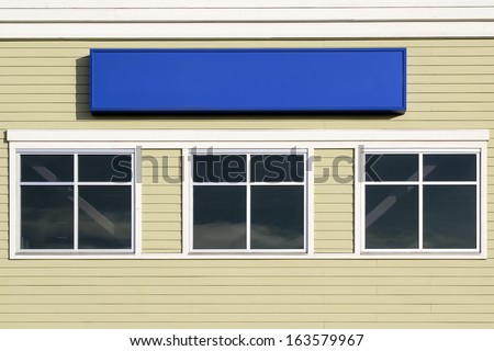 Blank Sign Above Windows Outside For Commercial Hospital Clinic or Business Office Building