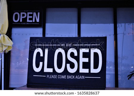 closed and open sign in front of a restaurant