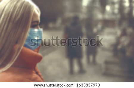 Woman wearing face mask because of air pollution in the city. blur picture