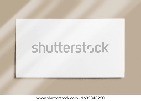 Blank layout of paper card  or lookbook isolated on grey background with linear overlay shadows as template for graphic designers presentations, portfolios etc.