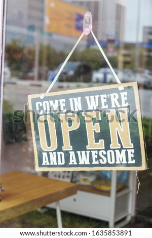 open sign hanging on cafe glass window 