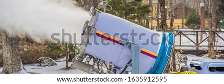 Snowmaking or cannon at the park. Snow machine produce snow for ski resort. Snow cannon during snowmaking slope BANNER, LONG FORMAT