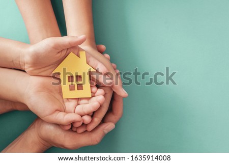 hands holding paper house, family home, homeless housing crisis, economic depression, mortgage concept Royalty-Free Stock Photo #1635914008