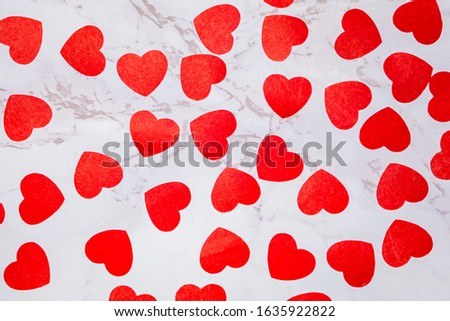 Paper hearts on a marble background. Background to the day of St. Valentine. Valentine's Day