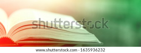 The books magic light with the bright shining down  background. Imagine a picture book concept background. knowledge concept learning technology. education kids books isolated.book opened on a wooden 