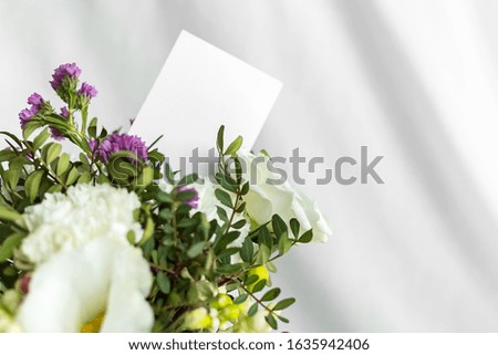Postcard with a flowers and an empty tag for text. Romantic greeting and surprise. Concept of love, birthday, Happy mother's Day and Valentine's Day on white background. Selective focus. copy space