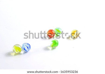 Six colored glass balls on a white background