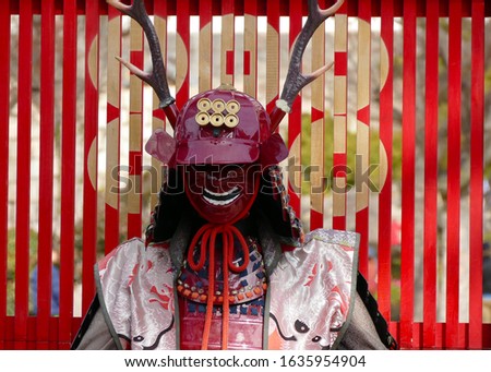 Portrait of Japanese Samurai traditional Red armor and helmet with mask while show at Osaka castle, Japan 2020