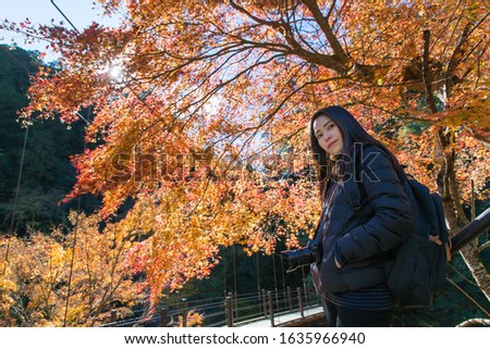 Happy Asian female tourists and beautiful scenery of autumn colors ,This is a famous place in Okutama, Tokyo, Japan