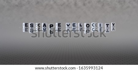escape velocity concept represented by wooden letter tiles