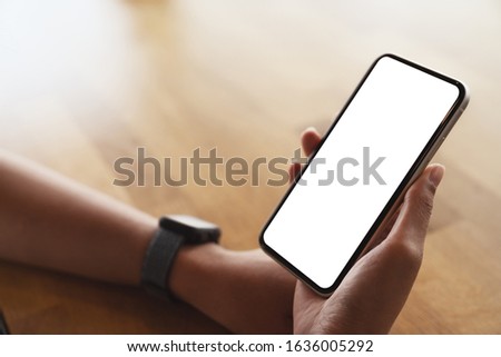 close-up on hand holding smart phone white screen display