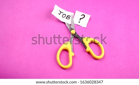 Job word cutting by scissor. Concept for downsizing or unemployment issues.