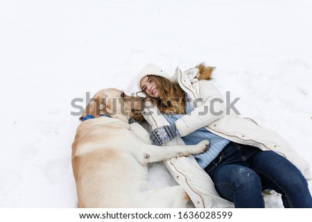 girl walking with dog in winter