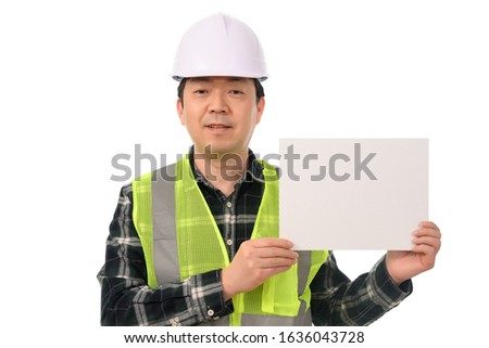 An Asian engineer holding a blank message board.