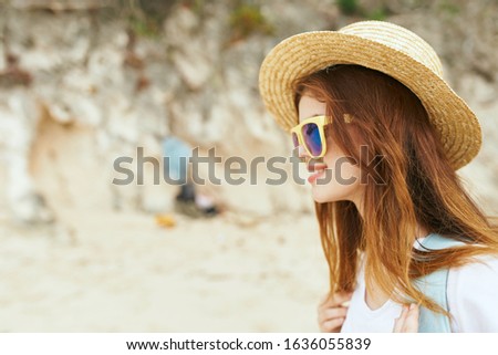 young woman in summer hat and glasses