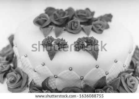 detail white wedding or brithday cake with red roses 