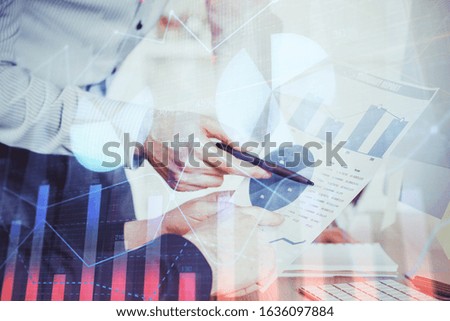 Financial trading graph double exposure with man desktop background.
