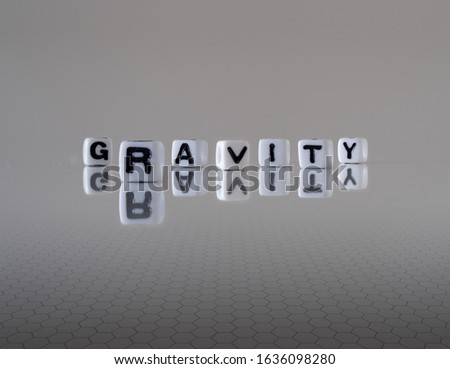 gravity concept represented by wooden letter tiles