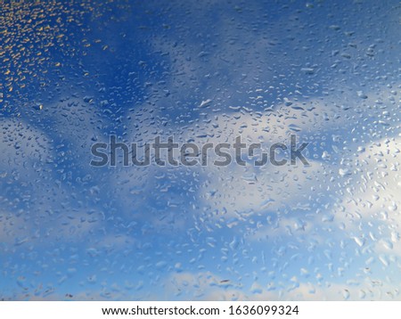 blue sky texture through glass with water drops