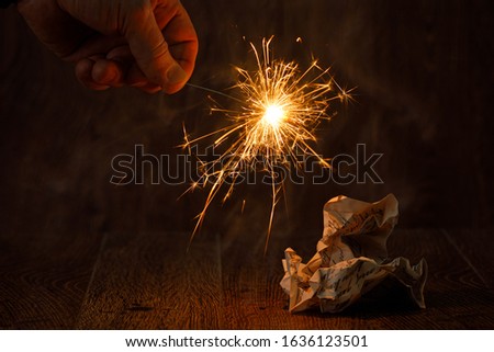 A person burning a love letter in the magic fire of bengal light