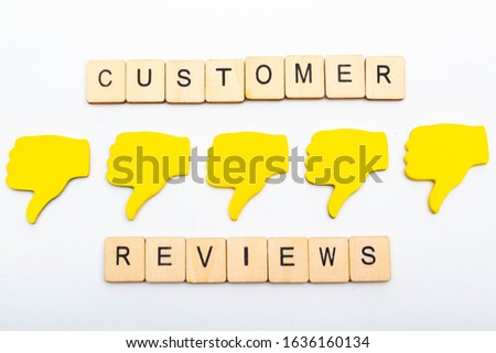 Customer feedback concept showing five yellow hands isolated on a plain background showing a sign reading customer reviews and five thumbs down