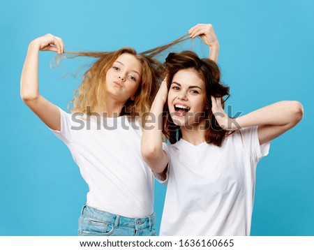 Mom and daughter in white t-shirts joy family lifestyle