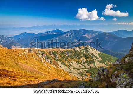 Mountainous landscape with hills and valleys at a sunny day in autumn season. The Low Tatras National Park in Slovakia, Europe.