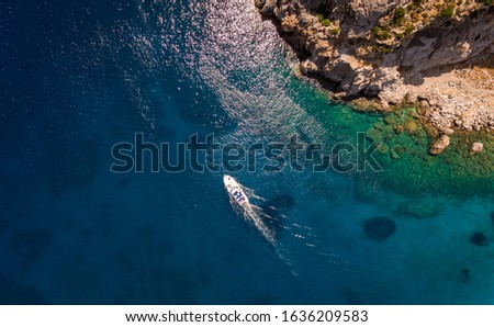 Aerial view on the boat sailing at the sea. Summer vacation concept.