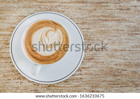 A cup of coffee late art with space on wood background, for a quiet moment