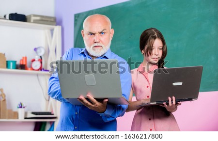 Coding is my spirit. new technology in learning. small girl with man tutor study on computer. education blogging. Back to school. school lesson online. Search engine. mature teacher help pupil girl.