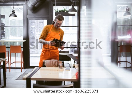 Young Waiter at Fast Food Restaurant
