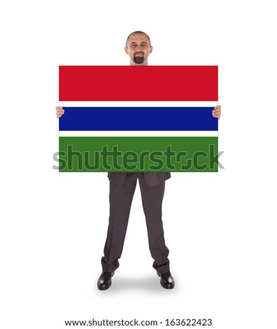 Smiling businessman holding a big card, flag of The Gambia