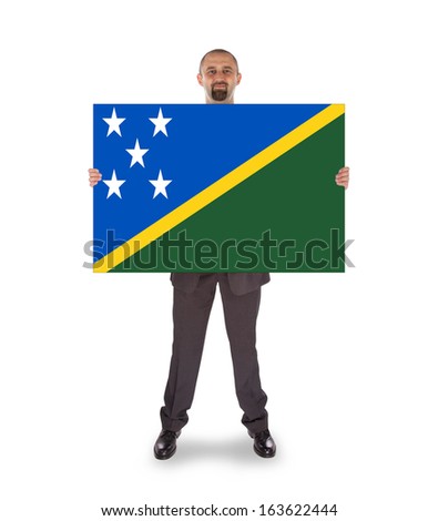 Smiling businessman holding a big card, flag of The Solomon Islands