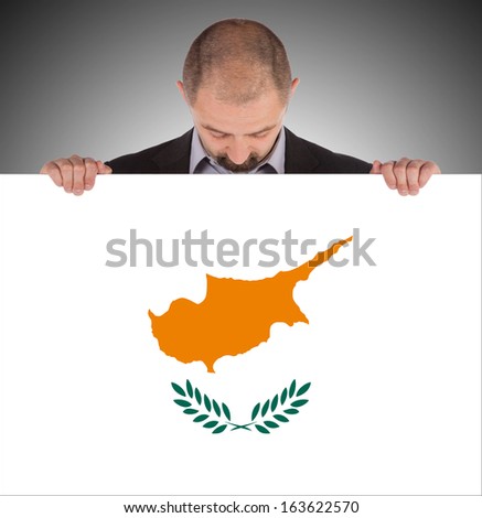 Smiling businessman holding a big card, flag of Cyprus
