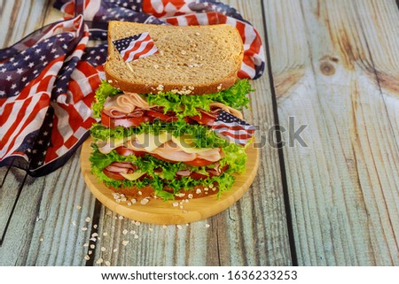 Big sandwiche with ham, cheese and tomato for american holiday party table.