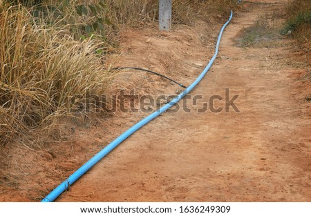 Blue pipe for waterworks are located in arid ground, no water