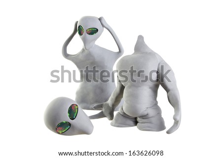 gray alien made of clay on a white background