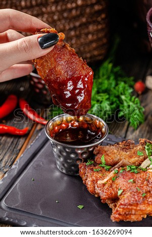 European cuisine in Ukrainian style. chicken legs and wings breaded with barbecue sauce. rustic style photo. background image, copy space text
