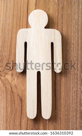 Male restroom notation made from light colour wood on teak wood background