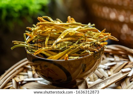 Dried Day Lily in a bowl. Royalty-Free Stock Photo #1636312873