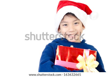 Portrait of Asian cute boy with red gift box in christmas hat isolate on white background . 