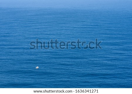 Small Boat On A Vast Open Ocean