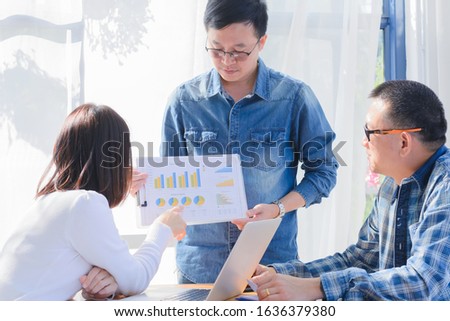 Business People Having a Meeting and young businessman presenting financial graph to his team business  