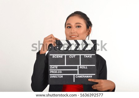 Attractive young Asian women holding clapper board isolated on white background.